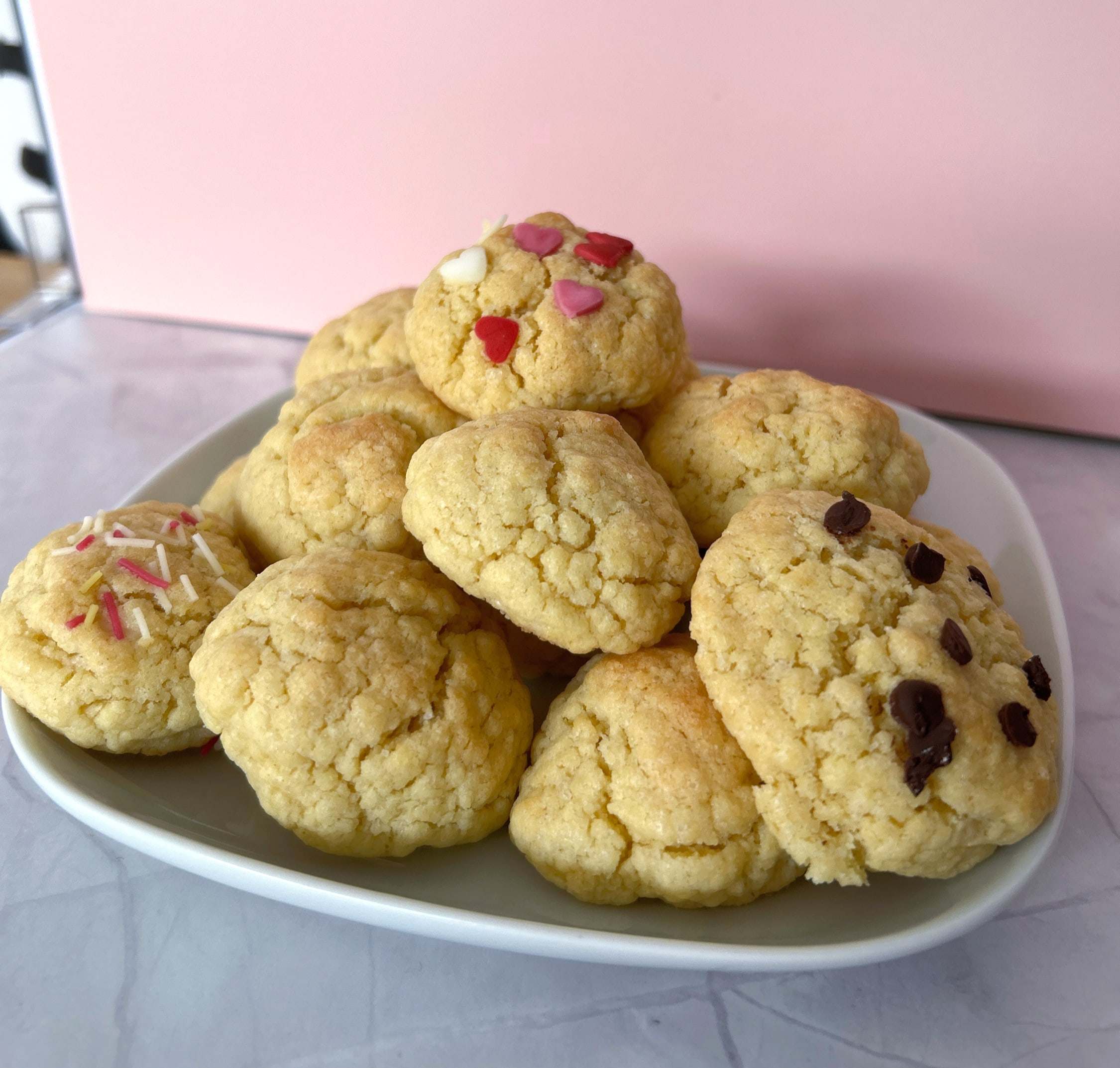 Plate of homemade cookies with chocolate chunks and pink candy hearts
